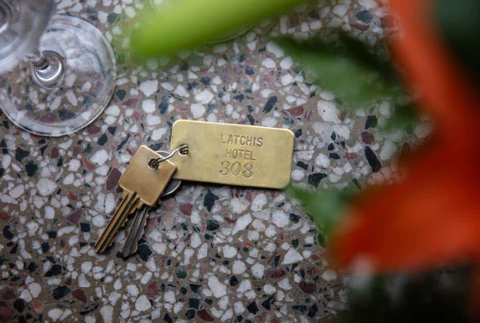 Close up view of old keys on a gold key chain showing Latchis Hotel 308