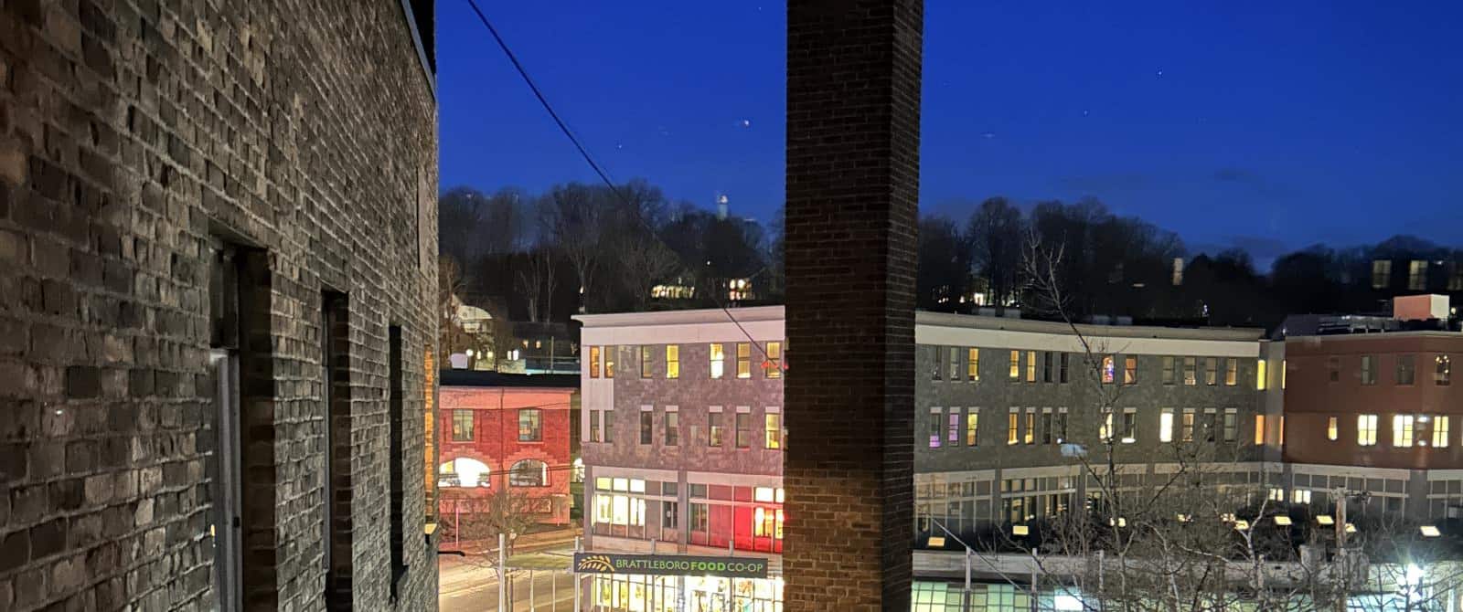 Bedroom view of downtown brick buildings at night