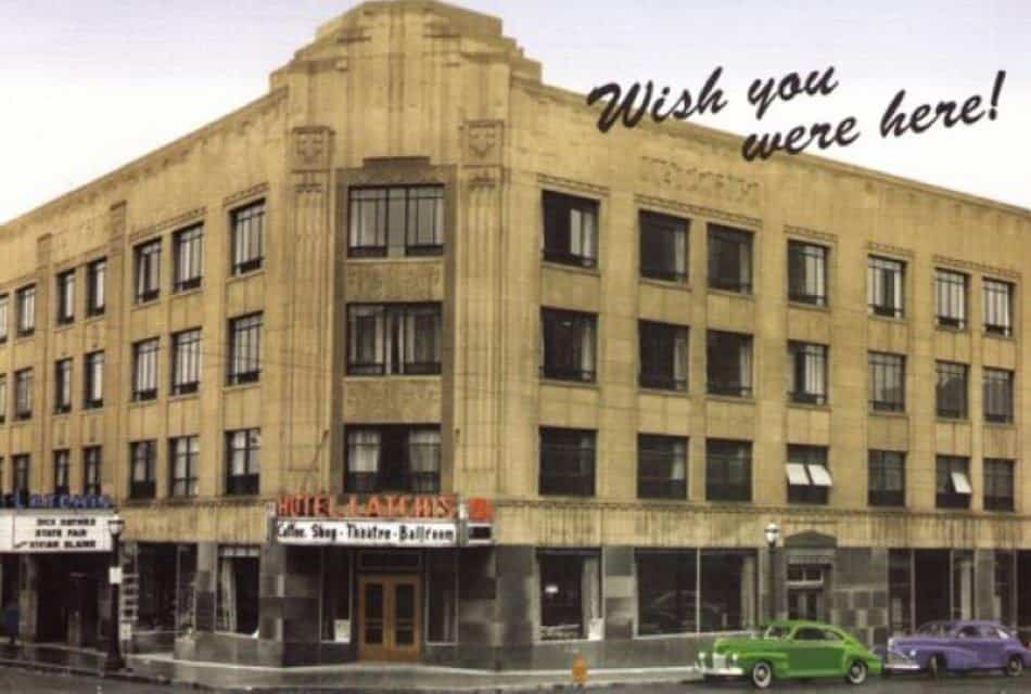 Exterior view of property which is an historic looking building on the corner of a downtown street from back in the 1940s