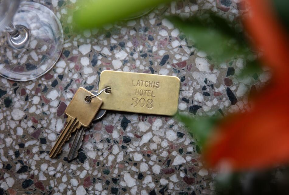 Close up view of old keys on a gold key chain showing Latchis Hotel 308