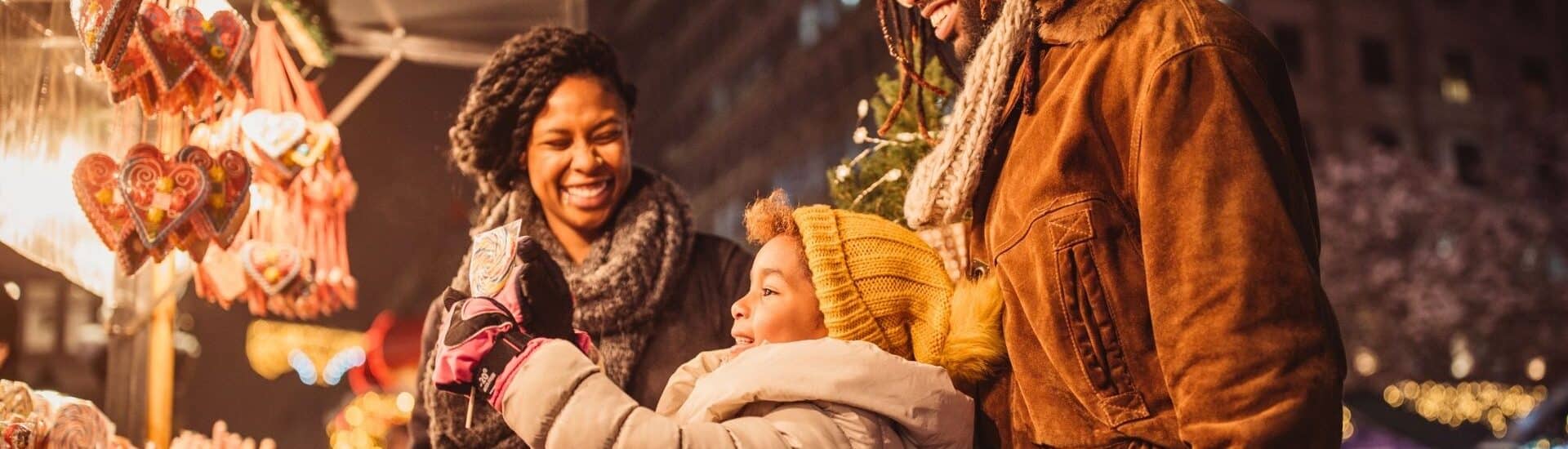 family holiday shopping at night in downtown