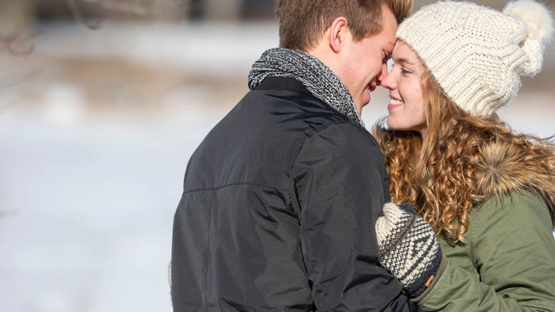 a romantic couple embracing in winter