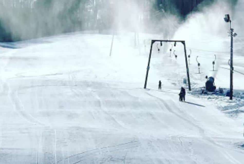 Ski slope with just a few skiers enjoying the snow